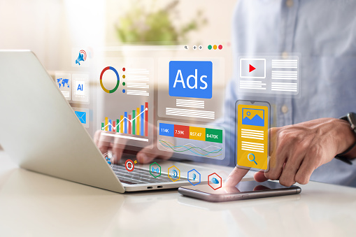 multifamily ai tools Person using a laptop and smartphone with floating digital marketing icons, including graphs, ads, and social media symbols. mpro Digital Edge