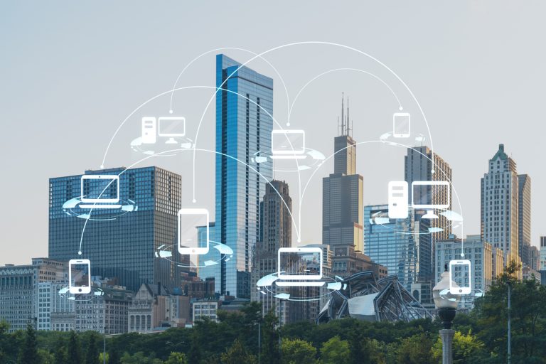 multifamily ai tools City skyline with digital device icons and connection lines overlaid, illustrating a technology network concept. mpro Digital Edge
